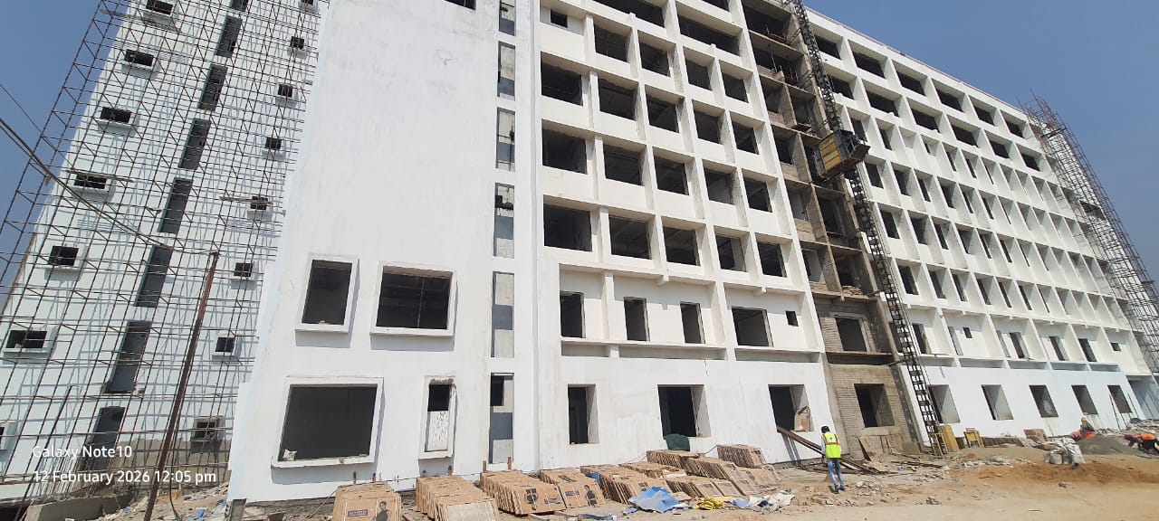 Large multi-storey block under construction with scaffolding and hoist in Visakhapatnam