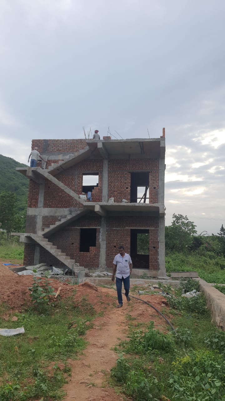 Two-storey duplex under construction with brickwork and RCC staircase